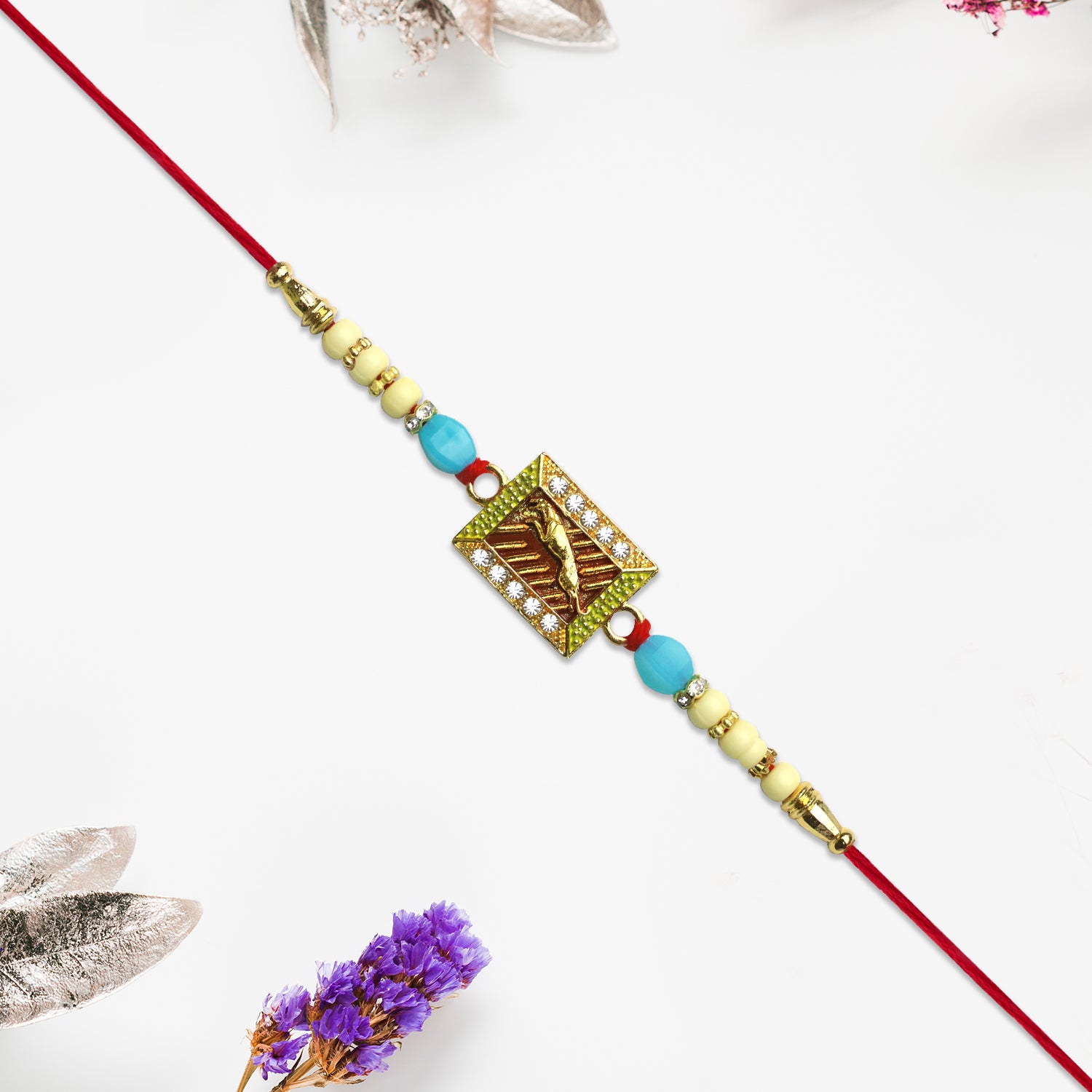 Leaping Deer Rakhi With Stone-studded Frame And Beads Leaping Deer Rakhi With Stone-studded Frame And Beads